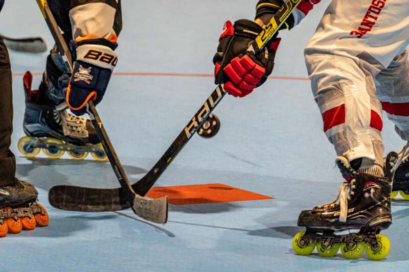 Photo of two players playing inline roller hocky 