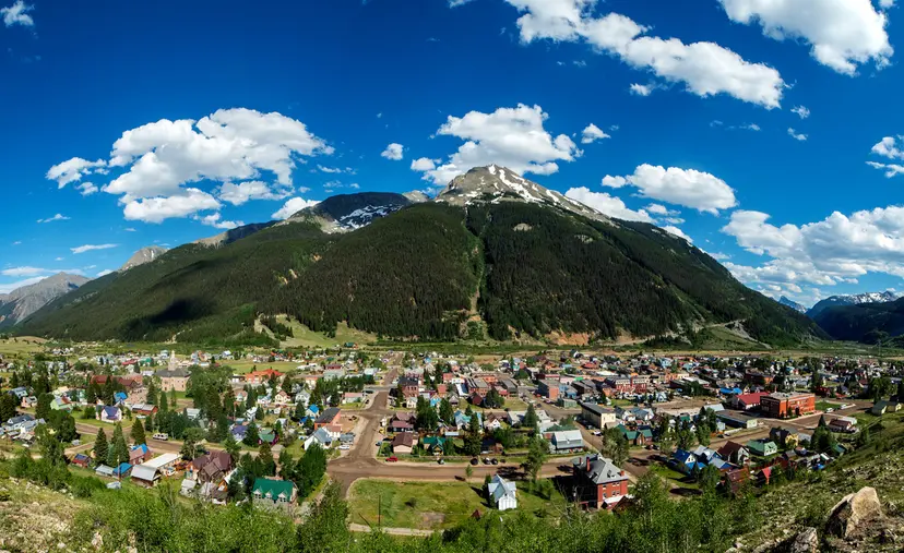 The image is of a mountain and the City of Gunnison